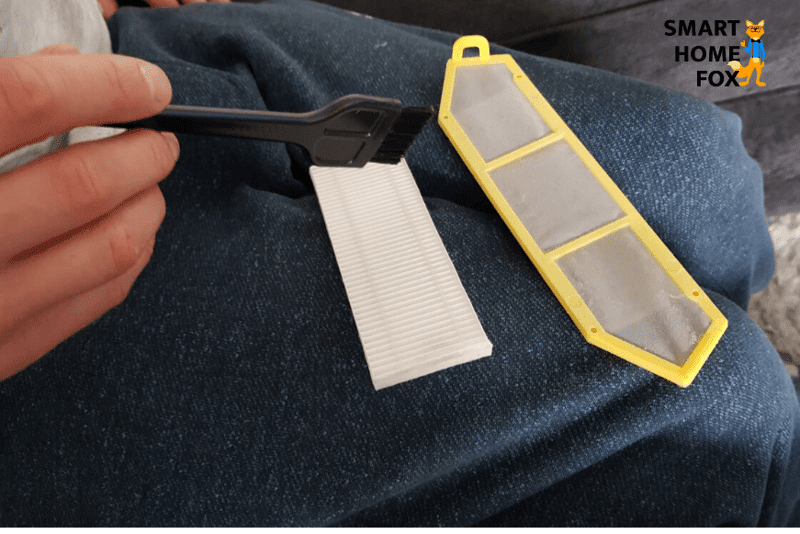 HEPA Filter des Easy Home Aldi Saugroboters wird mit einer Bürste gereinigt